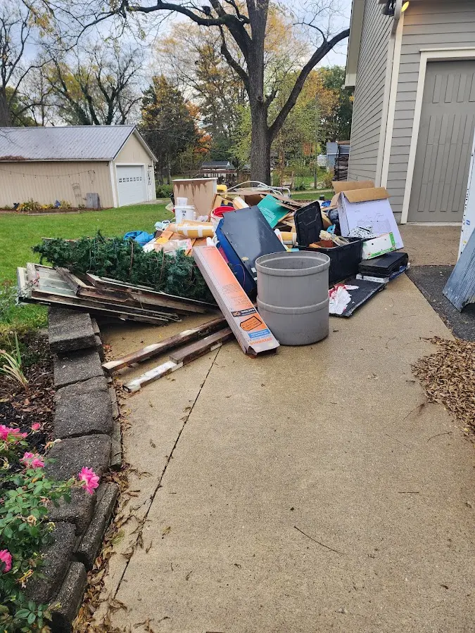 Dumpster being loaded with debris for Residential Dumpster Rental in Hamilton